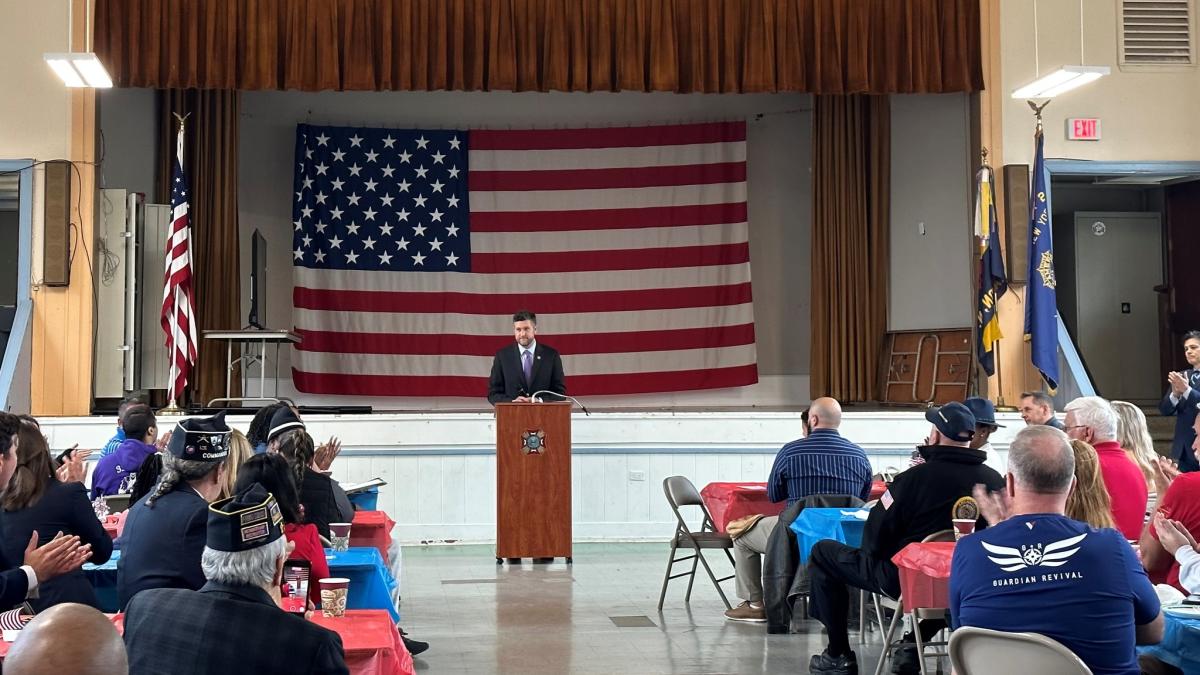 Congressman Ryan at the podium in front of large U.S. flag