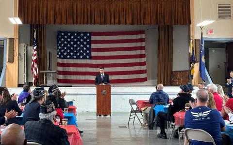 Congressman Ryan at the podium in front of large U.S. flag