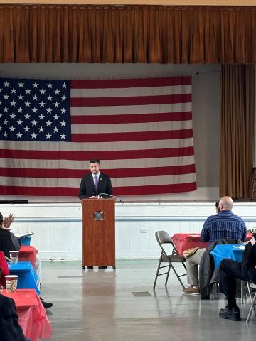Congressman Ryan at the podium in front of large U.S. flag